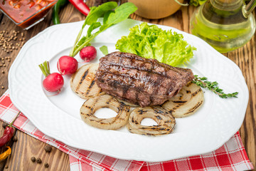 Fried grilled steak and vegetables on a plate