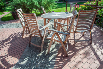Obraz premium Chairs and glass table on brick terrace at countryside 
