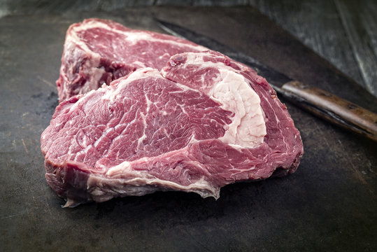 Dry Aged Rib-Eye Steak as close-up on old Metall Sheet