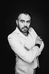 Portrait of man in white suits on dark background