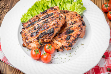 roasted chicken with herbs served on a plate with vegetables