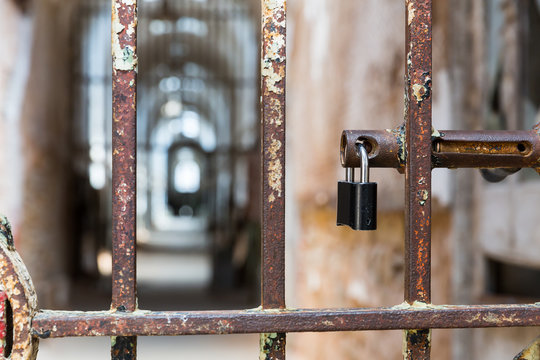 Door lock on rusty metal cell in old prison.
