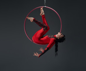 Young slim gymnast with red hoop artistic portrait