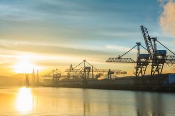 Fototapeta premium sunrise view to Bilbao industrial cranes, spain
