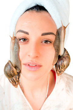 portrait of young darkhaired woman with snails achatina giant on her face