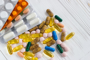 many colored medicine pills on white background