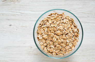 spelt flakes on wooden surface