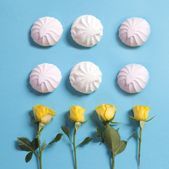 Pattern with marshmallows and yellow rose as ornament on a blue background. Fresh design for printing The summer theme.