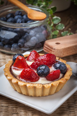 Fresh homemade fruit tart with strawberries and blueberries.