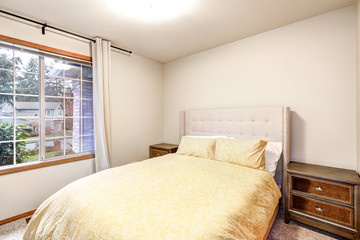 Fototapeta premium Beige bedroom interior features yellow bed