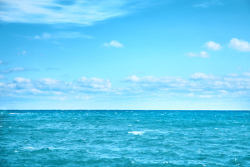 Fototapeta na wymiar Sea water and blue sky with white clouds