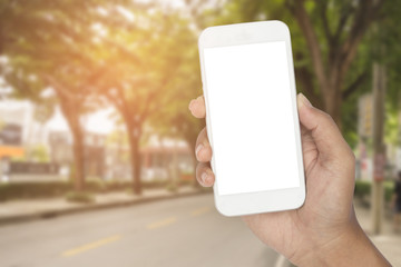 Hand with smartphone on the road.