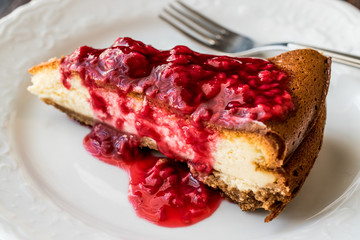 Homemade Raspberry Cheesecake in white plate.