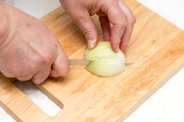 Obraz na płótnie Canvas Cook chopped onion on the board