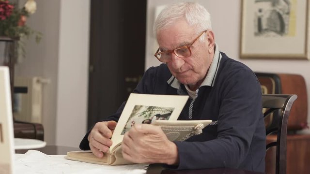 Pensioner leafs through his marriage's photo album 