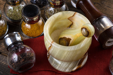 spices in Jar with mortar on wodeen background