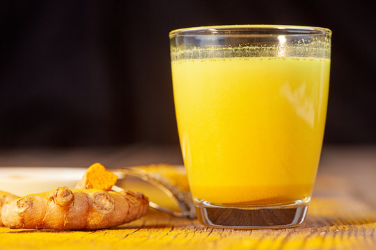 Turmeric golden milk with root and powder