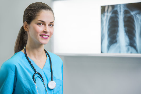 woman doctor or nurse is standing in front of an x-ray illuminator