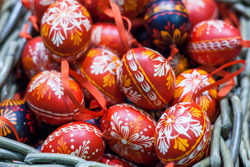 Many Easter eggs lie in the form of toys in the basket. Celebratory background.
