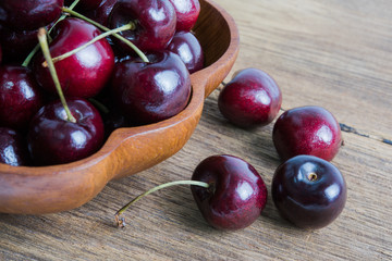 Cherry fruit in the wood bowl