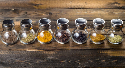 powder spices in glass jar on white background