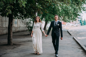 happy bride and groom at a park on their wedding day