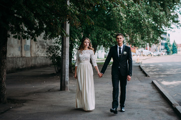 Fototapeta premium happy bride and groom at a park on their wedding day