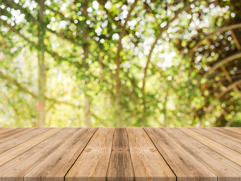Wooden board empty table in front of blurred background. Perspective brown wood table over blur trees in forest background - can be used mock up for display or montage your products. spring season.