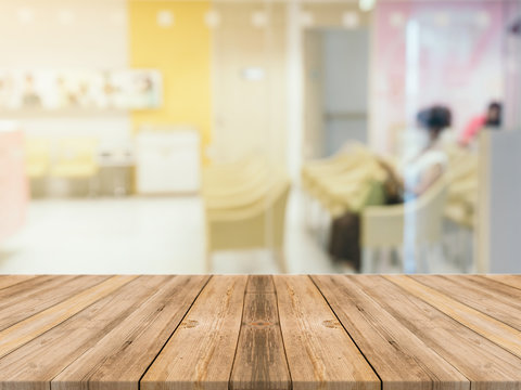 Wooden board empty table in front of blurred background. Perspective brown wood table over blur room in hospital background - can be used mock up for display or montage your products.