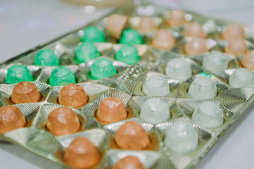Sweet bar on summer wedding. Layer cakes with protein cream and fresh cherry and berries on a cake stand outdoors