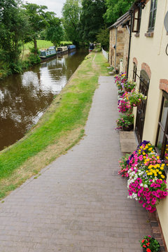 Canalside cottages and narrowboats on the Llangollen branch of the Shropshire Union canal  in the UK