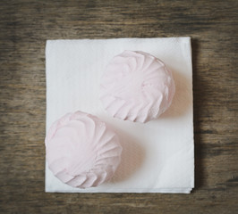 two marshmallow on a wooden table closeup
