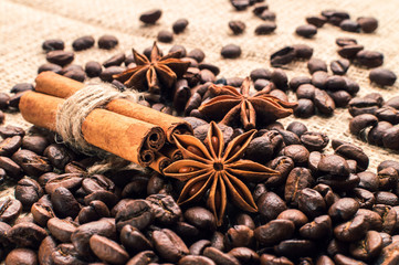 Coffee beans with cinnamon and anise on the sackcloth
