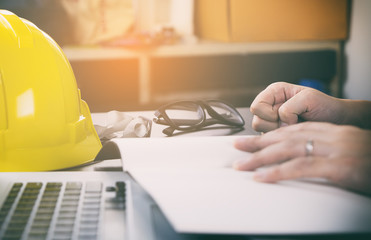 Engineer construction is having trouble with his project. His fist hitting the table.