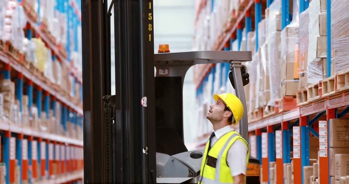 Male warehouse worker checking stock for shipping