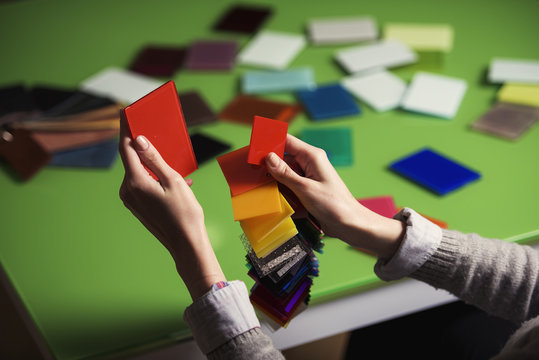 a young business woman is matching colors using samples