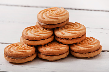 Tasty baked cookies on old wooden background.