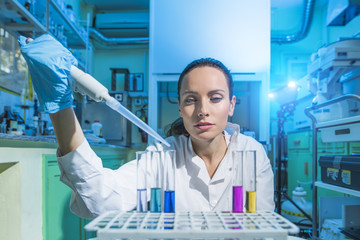 Beautiful Woman Scientist in her lab performing Chemistry experiments