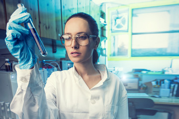 Beautiful Woman Scientist in her lab performing Chemistry experiments