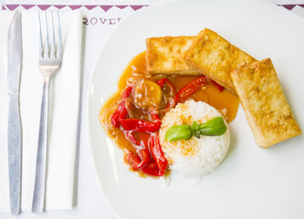 Rice with fried tofu and sauce from a paprika