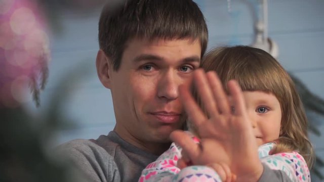 Close-up of a father with his little daughter says