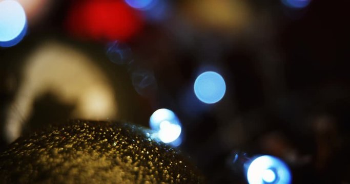 Close-up of christmas bauble with christmas lights