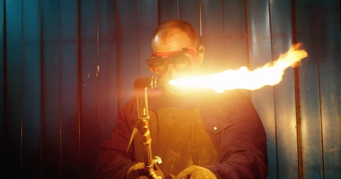 Male welder using welding torch