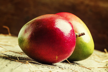 Fresh mango on vintage wooden background, selective focus