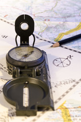 looking for the right route, still life with compass over an old and new map. travel. route. direction.