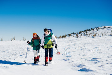 Loving couple traveling in winter mountains