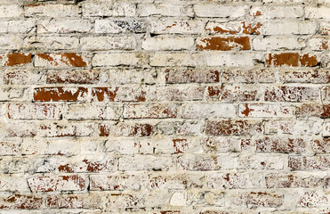 Background of a brick wall covered with lime