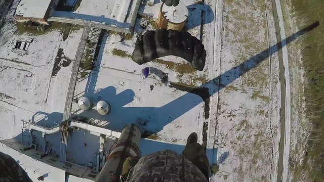 three people are jumping from chimney at winter during the bright day and cold weather