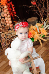 beautiful little girl with toy smiling at the camera