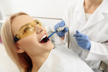 Odontologist taking care of patient teeth